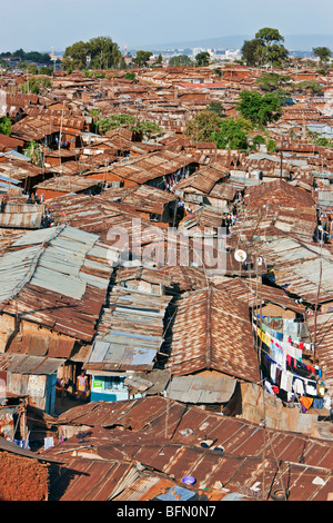 Kenya, Nairobi. A crowded part of Kibera, one of Nairobi  s largest slums, with the city centre visible in the distance Stock Photo