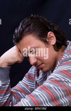 Sad young man head in hand Stock Photo