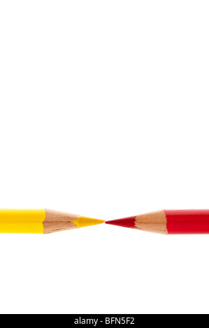 Brightly colored red and yellow pencils isolated on white Stock Photo