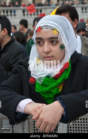 Celebrating Newroz the Kurdish New Year - banned in Turkey - in London, Young woman in traditional headscarf Stock Photo