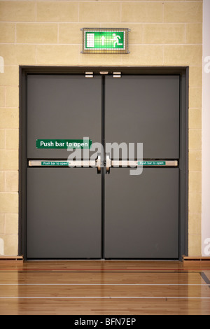 closed push bar to open emergency exit double doors in the uk Stock Photo