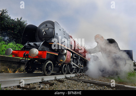 A model railway enthusiast with a hand built steam model of a Stanier LMS Coronation Class 4-6-2 pacific steam locomotive. Stock Photo