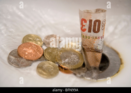 English money going down the drain Stock Photo