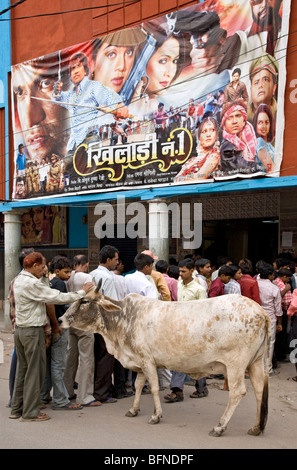 Men (and cow) waiting for the matinée showing. Imperial cinema. Paharganj. New Delhi. India Stock Photo