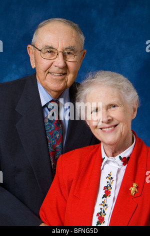 Happy senior citizens posing for an anniversary picture. Stock Photo