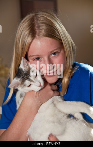 Junior high girl cuddling her cat. California  2009  MR © Myrleen Pearson Stock Photo