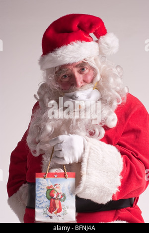 65-year-old man dressed as Santa Claus for Christmas wearing a breathing mask to protect against the H1N1 virus (Swine Flu) Stock Photo
