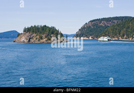 A washington State ferry cruises between two islands in the San Juan Islands of Washington State, USA. Stock Photo