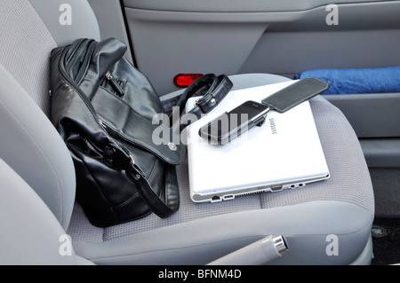 Samsung netbook iPhone & handbag left on passenger seat inside locked parked car Stock Photo