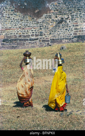 Indian women carrying balancing water pots on head ; Mandu ; Madhya Pradesh ; India ; asia Stock Photo