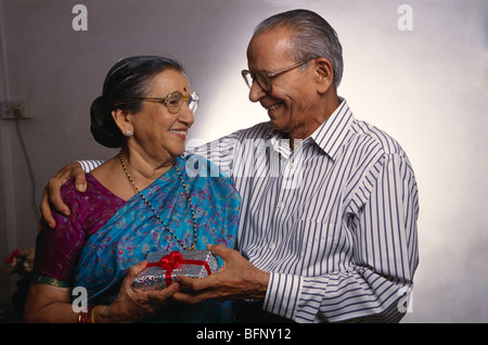 VPA 64098 : Old man giving gift to woman looking at each other MR#318;319 Stock Photo