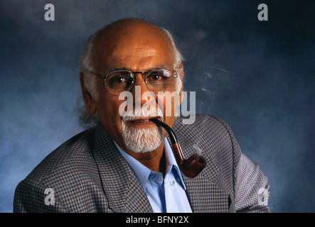 senior man portrait with white beard goatee wearing glasses and smoking pipe on blue background MR#372 Stock Photo