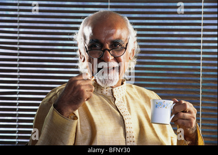 HMA 64122 : Old man smoking pipe and holding cup of tea MR#372 Stock Photo