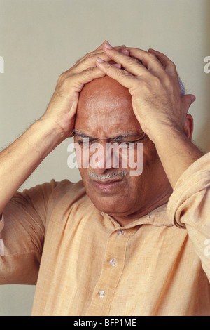 Man pressing his head suffering headache ; India ; asia ; MR#176 Stock Photo