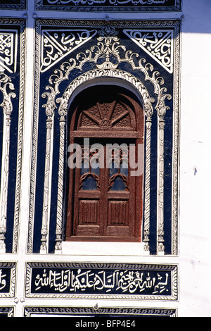 Wooden window & wall decorated by verses in Arabic Chhota Imambara ; Lucknow ; Uttar Pradesh ; India Stock Photo