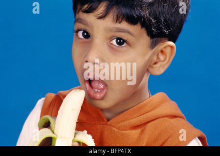 Indian boy child eating banana ; india ; asia ; MR#152 Stock Photo