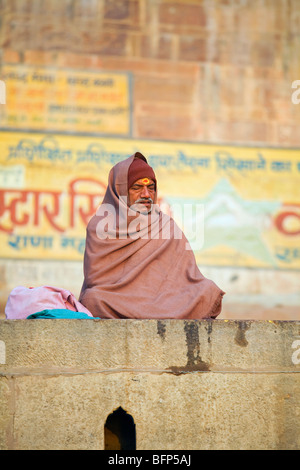 A man meditates on the banks of the Ganges River at the Hindu holy city of Varanasi, India in Uttar Pradesh state. Stock Photo