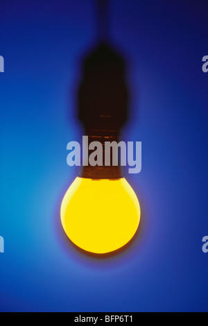 Incandescent electric light bulb ; incandescent lamp ; incandescent light globe ; on blue background Stock Photo
