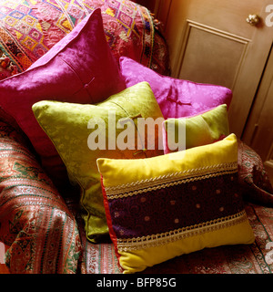 Sofa with Indian cover and bright silk cushions Stock Photo