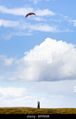 A young man flying a power kite in high winds on moorland east of Syre, Sutherland, Highland, Scotland Stock Photo