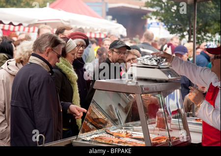 Customers buying freshly cooked fish at Kalaryssäys Kalaryssaeys market fair in Kuopio City Finland Stock Photo