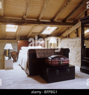 Bedroom in 17th century barn renovation with original oak rafters Stock Photo