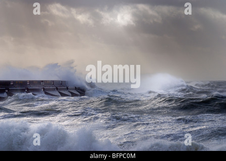 Waves in a stormy sea crash over Brighton marina Stock Photo