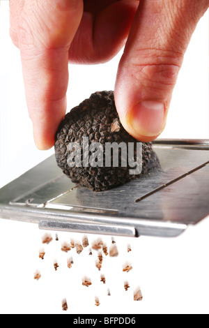 the mushroom of truffle is ground on a grater on a white background Stock Photo