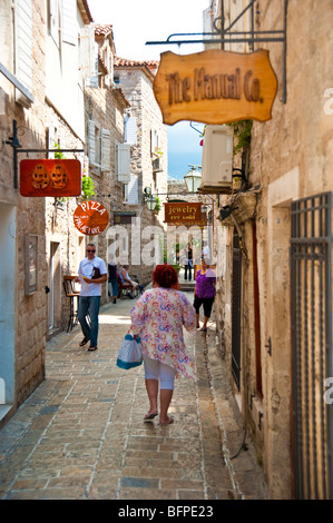 Narrow street with shops and restaurants at historic old town of Budva, Montenegro Stock Photo
