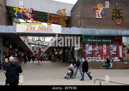 Christmas shoppers and decorations on Old Basing Mall Basingstoke Hampshire England Stock Photo