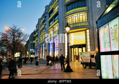 Paris, France, People Shopping, Street Lights, Storefront ,French Luxury Fashion Shop, LVMH Louis Vuitton building store, Avenue Champs Elysees, Stock Photo
