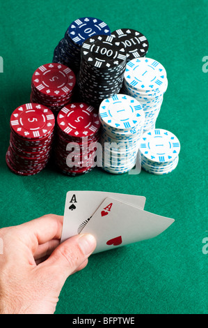 Poker hand with stack of winning chips Stock Photo