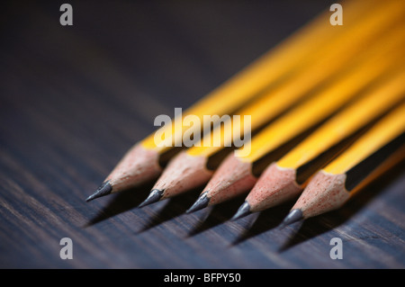 Five pencils, yellow pencils, sharpened pencils on black baackground Stock Photo