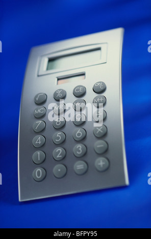 Calculator on blue background Stock Photo