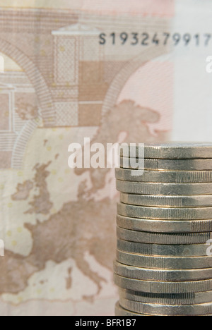 piled euro coins and banknote detail Stock Photo