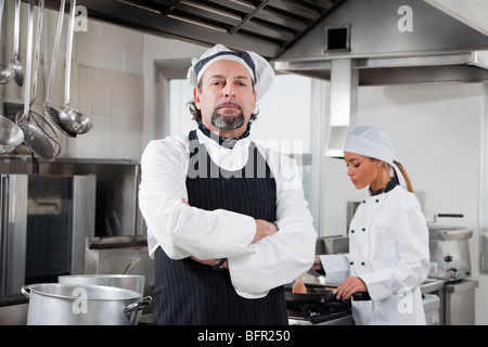portrait of confident chef looking at camera in kitchen Stock Photo