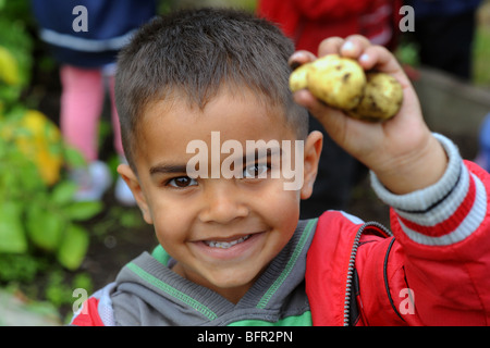 Children visit a local allotment near to the school to learn about healthy eating and gardening, West Yorkshire Stock Photo