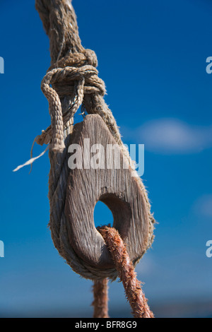 Knotted rope on a wooden pulley of a dhow Stock Photo