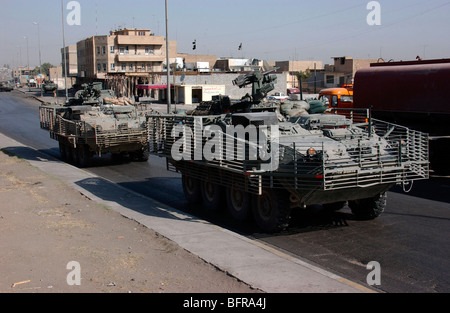 U.S. Army soldiers patrolling in Stryker armored wheeled vehicles as part of Operation Block Party. Stock Photo