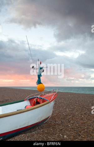 Stormy sunset & fishing boats at Cley beach on the North Norfolk Coast Stock Photo