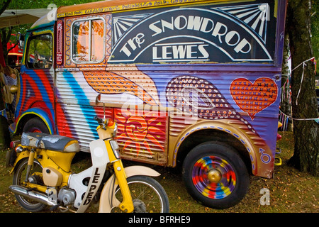 Colourful painted hippy VW camper van with The Snowdrop, Lewes lettering on the side. UK Stock Photo
