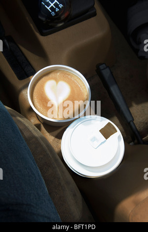 Two Coffees with Heart Design in Foam in Car Cup Holders Stock Photo