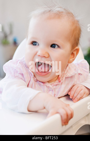 Baby Girl in High Chair Stock Photo