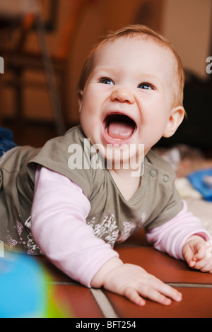 Happy Baby Lying on Floor Stock Photo