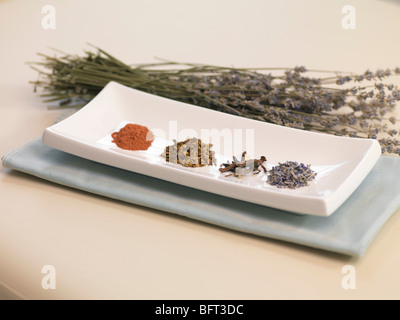 Dried Leaves, Roots and Spices in Dish Stock Photo