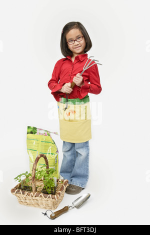 Girl with Gardening Tools Stock Photo