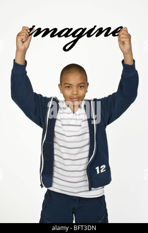 Boy Holding Imagine Sign Stock Photo