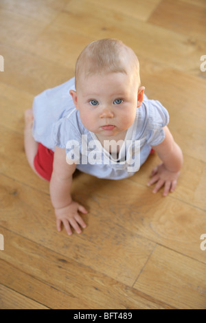 Baby Girl Crawling on the Floor Stock Photo