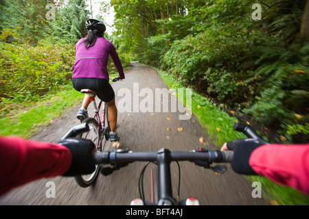 Women Riding Bikes in Forest Stock Photo