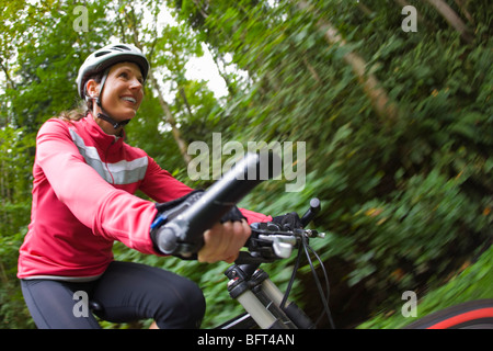 Woman Riding Bike in Forest Stock Photo